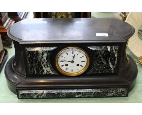 A black marble and variegated green marble mantel clock