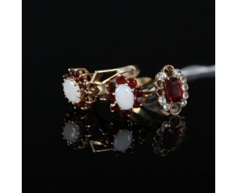 Two 9ct gold garnet and opal cluster rings and a yellow metal paste set ring (some stones missing)