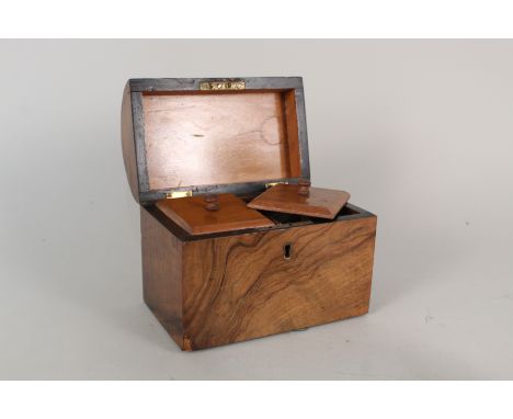 A Victorian walnut tea caddy with twin lidded compartments and domed lid