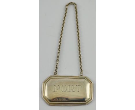 A silver decanter label of canted rectangular form engraved 'port', London 1931