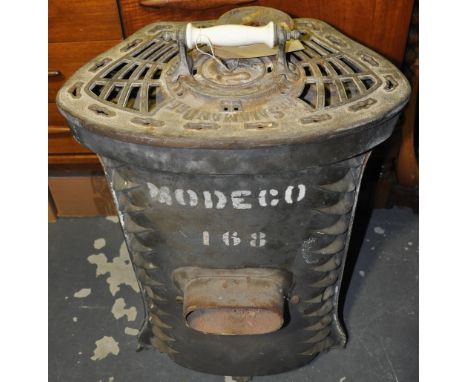 An early 20th Century French salamandre green enamel cast iron solid fuel heater with Art Nouveau style panels, H. 72cms