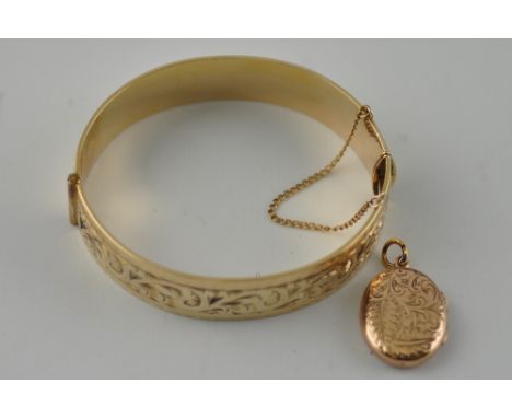 A 9ct gold plated bangle together with a yellow metal locket