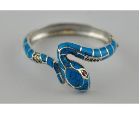 A silver and turquoise coloured stone snake bangle 