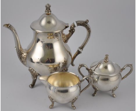 A three piece silver plated tea set, with leaf cap scroll handles, on four leaf mounted scroll feet, the teapot with hinged d