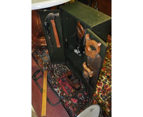 A vintage 'Macrome' green metal two door carpenter's wall cabinet enclosing assorted tools to include a smoothing plane, wood