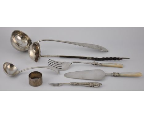 An early 19th century Irish silver whalebone handled ladle, a continental white metal ladle, napkin ring and 4 other pieces o