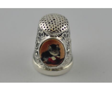 A silver embossed thimble set with pictorial enamel image of a kitten