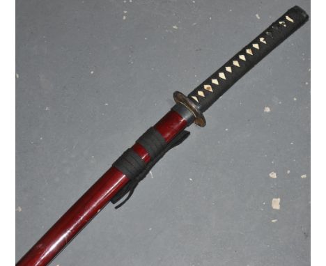 A large reproduction Japanese katana sword with parcel gilt tsuba and red lacquer scabbard