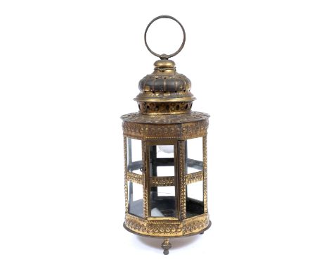 AN ANTIQUE 19TH CENTURY CYLINDRICAL LANTERN with faceted sides, suspension loop and turned feet, pressed floral decoration ov