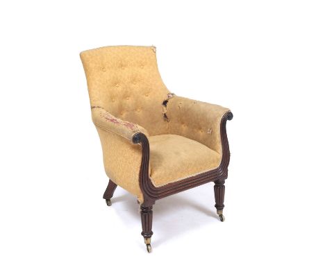 A WILLIAM IV BUTTON UPHOLSTERED LIBRARY CHAIR with reeded scrolls to the arm fronts and standing on turned tapering reeded fr