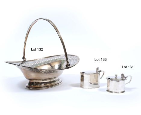 AN EDWARDIAN OVAL SILVER BASKET with hinged loop handle, pierced decoration and on a pierced conforming spreading foot, marks