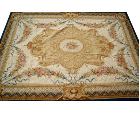 AN AUBUSSON TYPE CARPET on cream ground with blue border and floral sprays, approximately 295cm x 420cm 