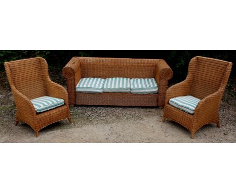 A WICKER CONSERVATORY SUITE consisting of a sofa with scroll ends, approximately 204cm wide together with two wicker armchair