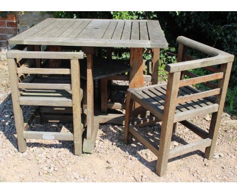 R A LISTER TEAK SQUARE GARDEN TABLE with four nesting chairs beneath, the table 91cm square 