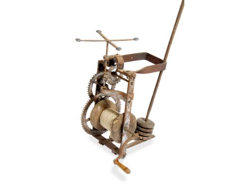 AN OLD WROUGHT IRON SPIT ENGINE with turned wooden winding handle, complete with spit rod, 57cm high