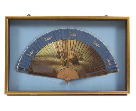 A 19TH CENTURY FAN, the wooden sticks decorated with a scene of figures harvesting grapes in the countryside, mounted in a ca