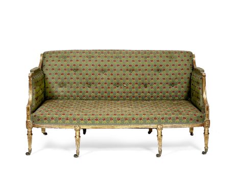 A GEORGE III GILT FRAMED SETTEE with green ground red flower button upholstery to the back, seat, arms and sides with scrolli