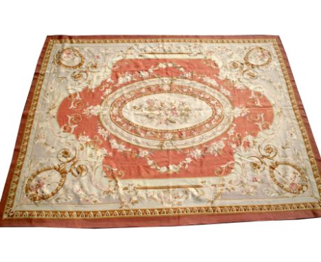 AN 'AUBUSSON' STYLE FORMAL CARPET, the central oval foliate medallion within a rose pink field, with scrolling borders, retai