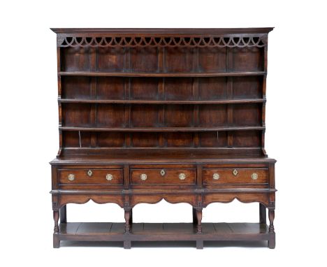 AN 18TH CENTURY OAK DRESSER, the three shelf plate rack above with panelled back over a base with three drawers with octagona