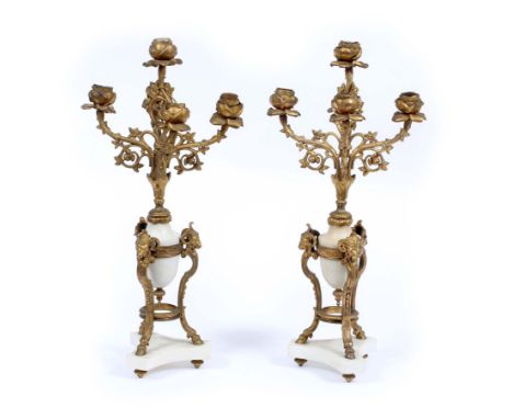 A PAIR OF GILT METAL AND MARBLE FIVE LIGHT CANDELABRA,  each with four rose cast arms, with rose candle sockets on a turned m