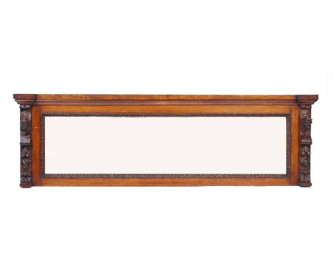 A VICTORIAN OAK FRAMED LONG RECTANGULAR OVERMANTLE MIRROR with carved figure head decoration 197cm wide 