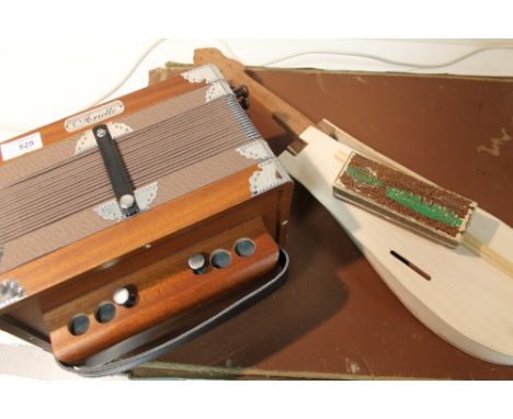 A MODERN ARIETTE ACCORDION TOGETHER WITH A GUITAR SHAPED STORAGE BOX AND A HARMONICA