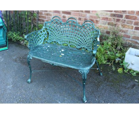 A PAINTED GREEN METAL GARDEN BENCH
