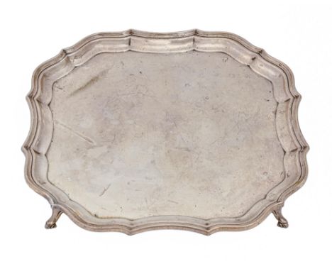 A George V silver salver, the plain field with a moulded border and on four hoof feet, the underside engraved with a presenta