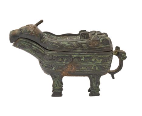 A Chinese bronze ritual wine vessel, guang/gong, in the form of a dragon, the decoration divided into registers and including
