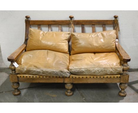 A distress walnut or similar wood and brass nailed hide three piece suite,&nbsp;sofa 120cm l, feather cushions  