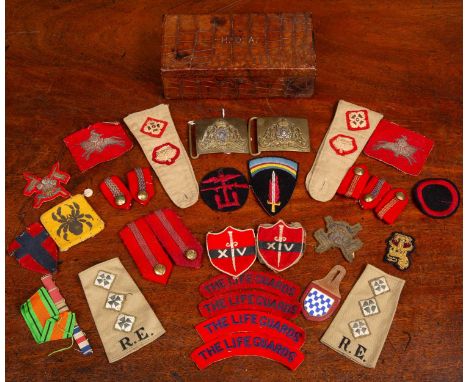 A collection of regimental tabs, buttons, buckles, shoulder tabs and campaign badges belonging to Philip Reginald Astley to i