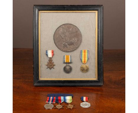 A Bronze WWI Memorial Plaque 'Frank Buckner', together with four medals to include a World Ward I medal trio and a further me