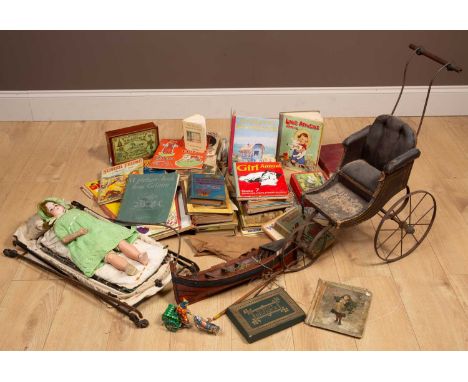 A collection of children's books and toys to include a bisque headed porcelain doll with kid leather body with its pram; a wo