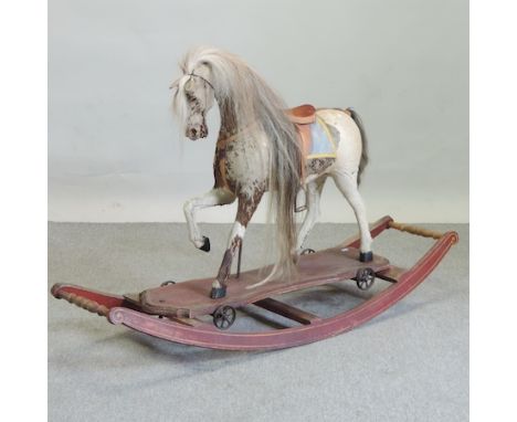 A late 19th century hide covered rocking horse, on a bow shaped rocker, 146cm long