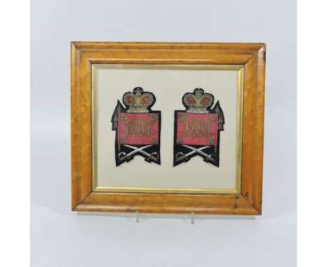 A pair of military epaulettes, in a display frame