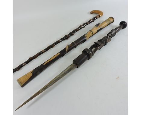 A tribal sword stick, together with another walking stick