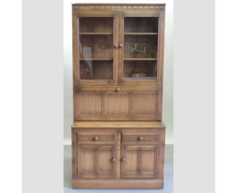 An Ercol medium elm cabinet bookcase, 98cm