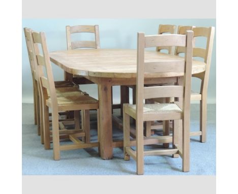 An light oak extending oval dining table, 240 x 120cm, together with eight ladder back dining chairs