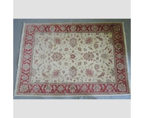 A modern woollen carpet, with floral designs on cream ground, 290 x 200cm