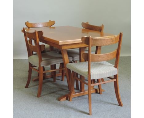 A 1950's oak tilt-top dining table, 66 x 126cm, together with a set of four ladder back dining chairs 