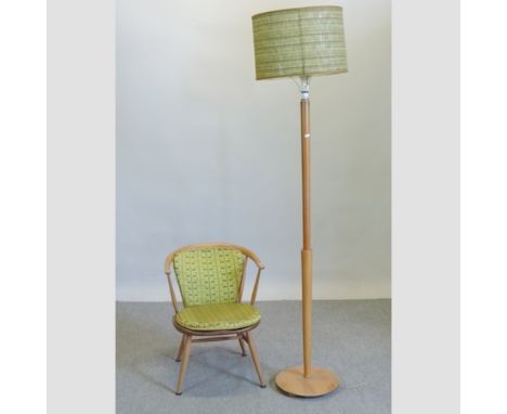 A 1970's Ercol light elm armchair, together with a standard lamp and shade