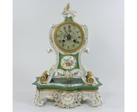 A 19th century French porcelain cased mantel clock on stand, the scrolled case painted with bouquets of coloured flowers, on 