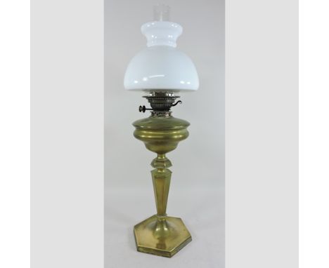 A brass oil lamp, with a white glass shade
