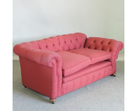 A red upholstered two seater Chesterfield sofa, 171cm