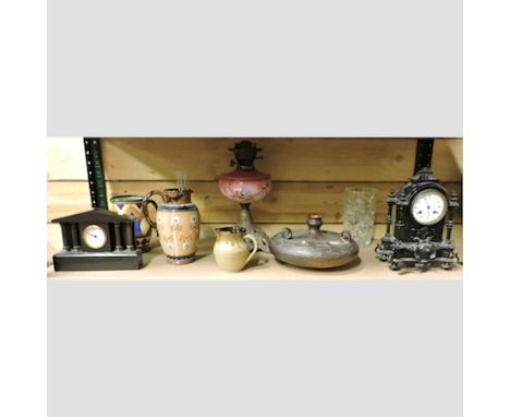 A 19th century black painted metal mantel clock, 30cm tall, together with a smaller black slate mantel clock, an oil lamp wit