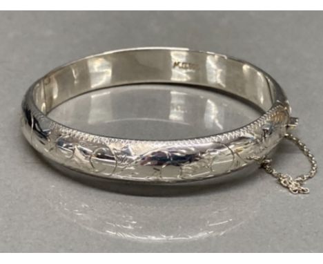A sterling silver bangle with safety chain 10.8g gross