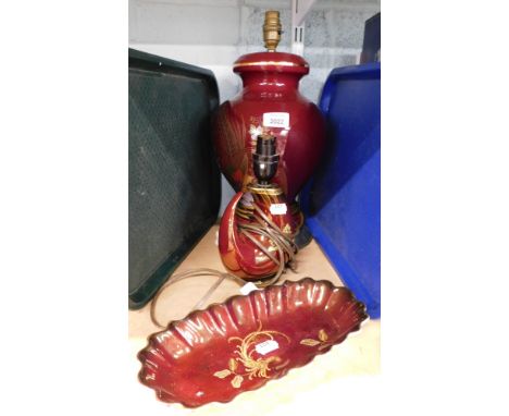 Three items of Crown Devon red lustre ware, to include a lozenge shaped ship, 25cm diameter, and two table lamps.&nbsp;
WARNI