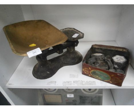 set of cast scales and a tin of weights