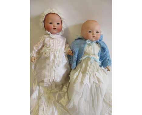 Two Armand Marseille baby dolls, comprising a 15" flange neck with blue glass eyes, closed mouth, fabric body and composition