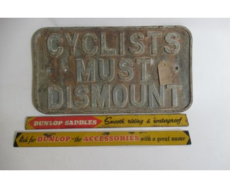 A cast iron Cyclist Must Dismount sign and two small Dunlop tin accessory signs (Est. plus 21% premium inc. VAT)
